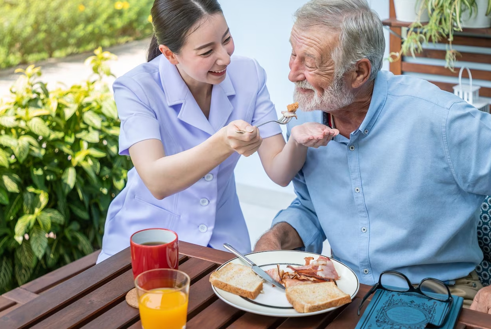 Care professional speaking with older clients